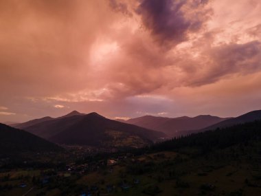 Dağların üzerindeki bulutlu gün batımı kopyalama alanı