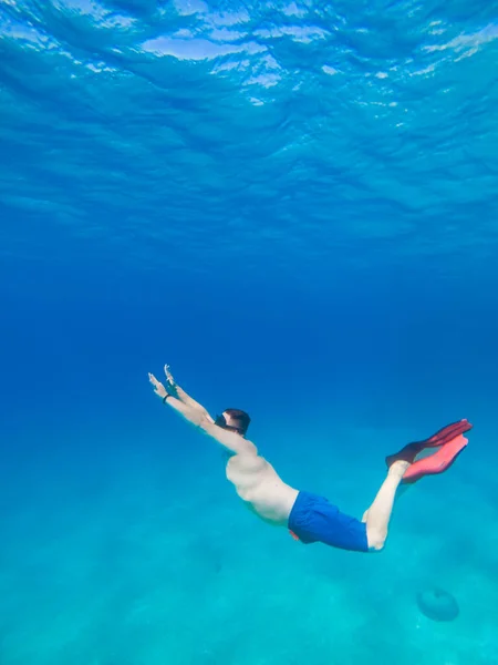 man underwater in scuba mask diving under water copy space
