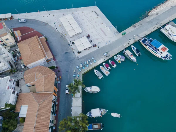 overhead view of car moving by road near sea harbor with boats and yachts Vasiliki town Greece