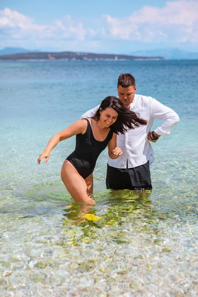 man with woman standing in sea couple together