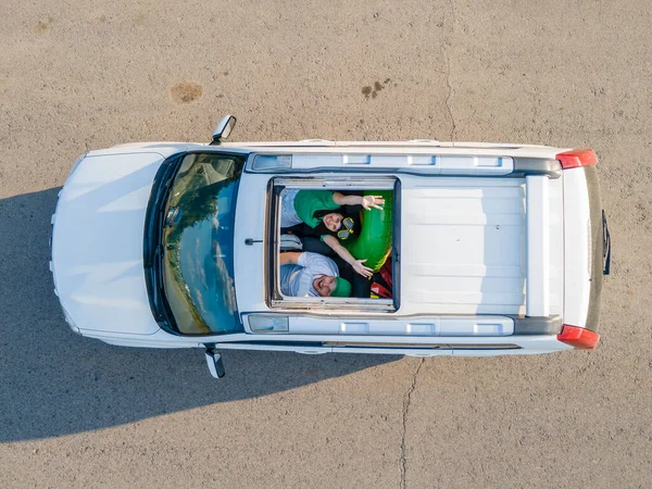 happy couple in car overhead view car travel to sea concept sunroof