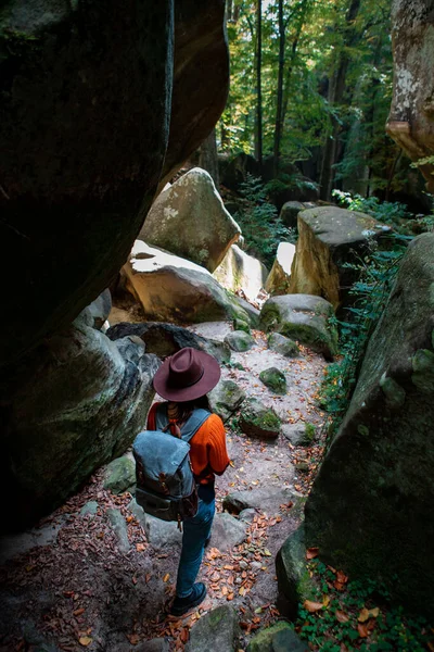 woman traveler with backpack walking by trail in canyon copy space