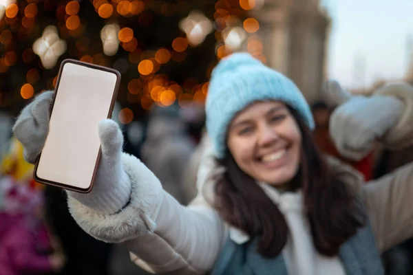 Smiling Happy Woman Christmas City Fair Holding Phone White Screen — Stock Photo, Image