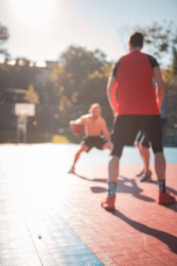 men playing basketball dribbling close up wide angle outdoors out of focus