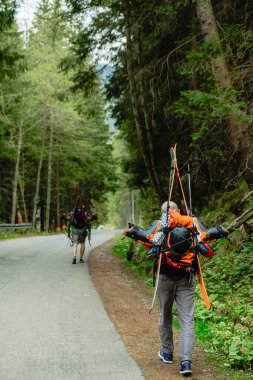 Man with ski is hiking on trail in National Park.
