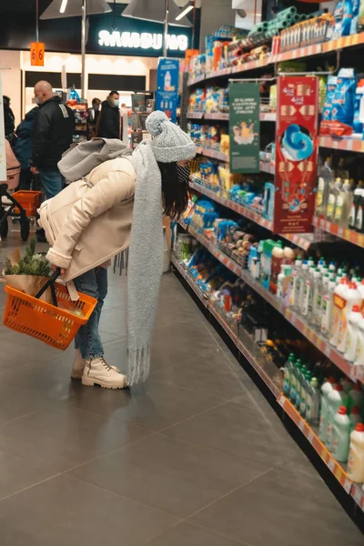 woman in winter outfit do groceries shopping copy space covid 19 mask