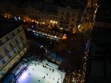 overhead view of Lviv city center at night christmas fair ski rink