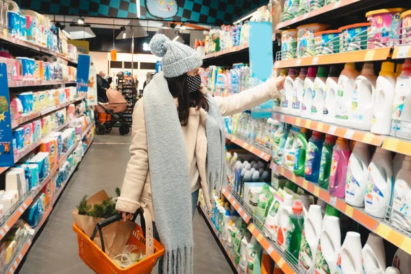 woman in winter outfit do groceries shopping copy space covid 19 mask