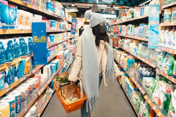 woman in winter outfit do groceries shopping copy space covid 19 mask