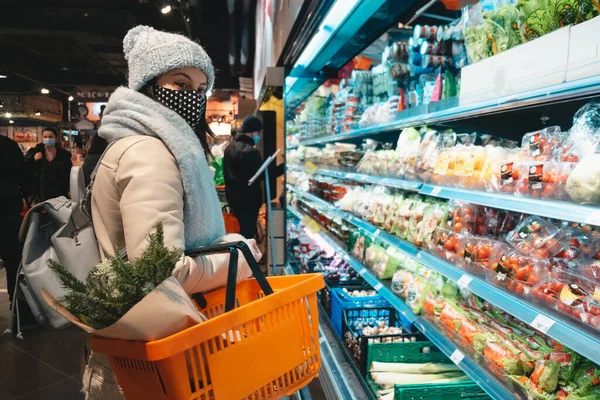 woman in winter outfit do groceries shopping copy space covid 19 mask