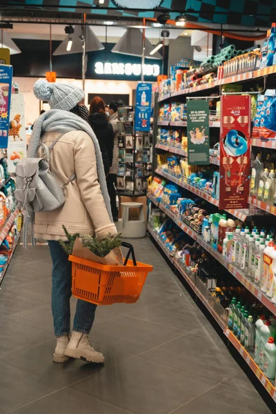 woman in winter outfit do groceries shopping copy space covid 19 mask