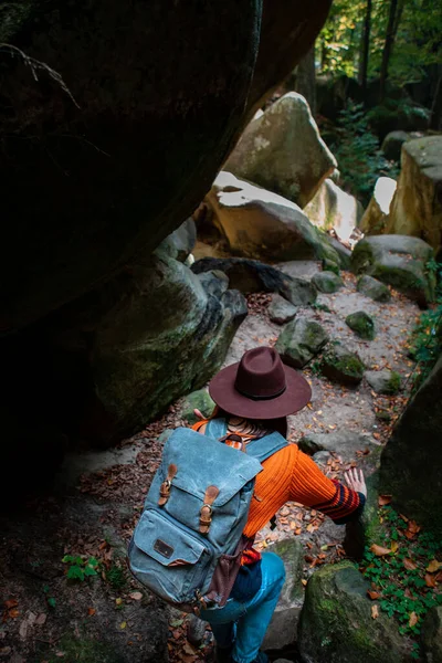 woman traveler with backpack walking by trail in canyon copy space