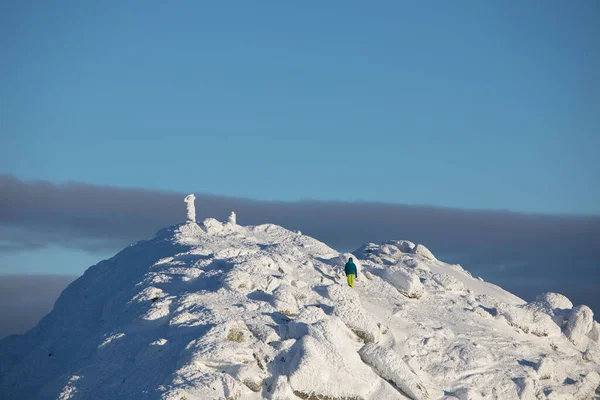 people climbing to the top of snowed mountains peak of Slovakia tatras