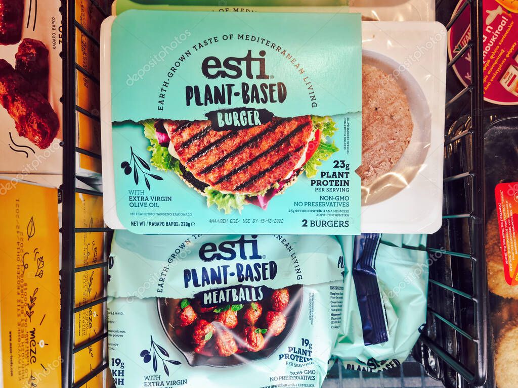 Plant based vegan meat on sale at supermarket. Store interior top view of packages with esti veggie burgers and meatballs as refrigerated at a supermarket.