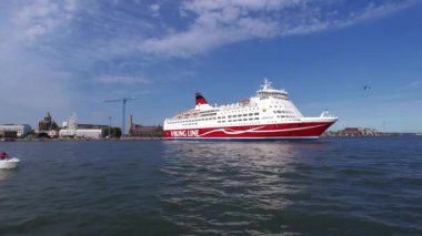 Helsinki, Finland - August 5 2022: Day sea view of Helsinki waterfront aboard a sailing ship passing from the harbour and Viking Line MS Amorella cruiseferry.