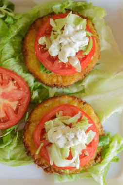 Tahtada salata ve domatesli hamburger hazırlığı