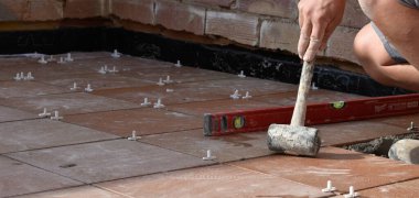 Hands of man working in masonry, unrecognisable