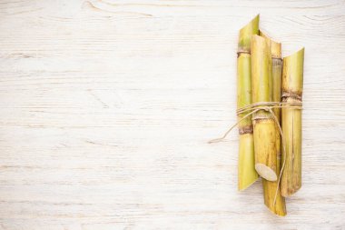 Beyaz ahşap arka planda yazı için şeker kamışına bağlanmış. Üst görünüm.