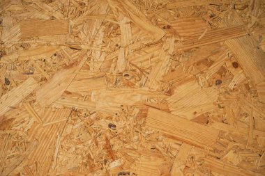 OSB yönetim kurulu dokusu. Kahverengi ahşap arka plan. Basit ütülü yonga deseni. Kahverengi ahşap doku. Çip tahtası arka planı. 