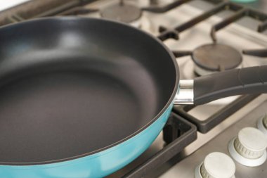 New frying pan on the stove, close-up.