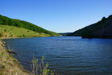 Amazing spring view of the canyon of the Dniester River with picturesque hills, fields, forests. Chernivtsi region, nature of Ukraine.