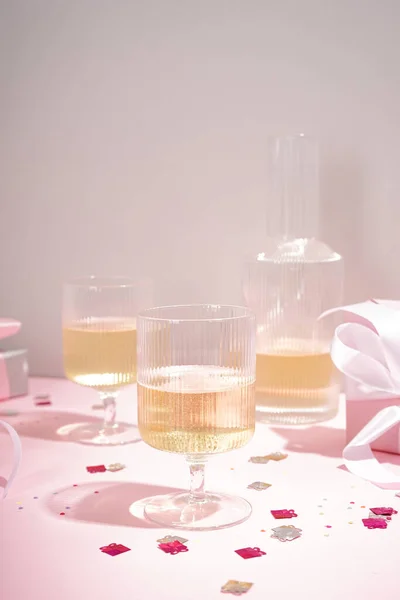 Σαμπάνια Ποτήρια Και Δώρο Ροζ Φόντο Χώρος Για Κείμενο Κάθετα — Φωτογραφία Αρχείου
