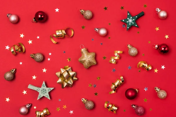 Red Background with Holiday Christmas Decoration Balls Confetti Christmas Wallpaper Flat Lay Top View Horizontal