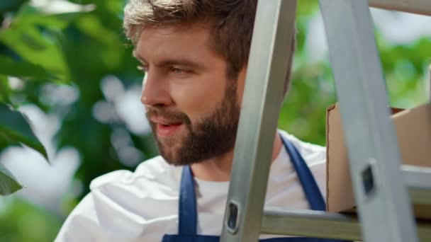 Man gardener collecting cherry wooden box on organic green plantation portrait — Stock Video