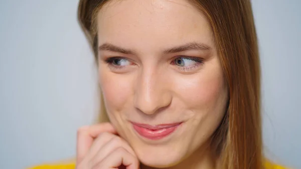 Close-up positieve vrouw het verzenden van lucht kus naar camera op grijze achtergrond. — Stockfoto