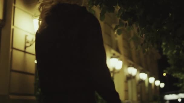 Femme s'éloigner rue à la fin de la nuit dans la ville moderne en plein air. — Video