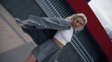 Şehrin arka planında duygusal olarak hareket eden olumlu kadın..