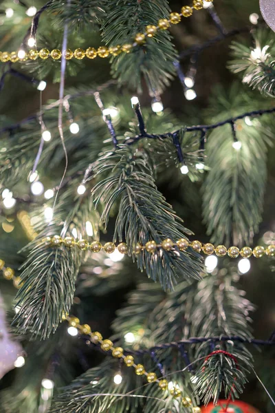 Mutlu Noel ağacı dalında altın bir çelenk. Yeni yıl çam ağacı süslemesi