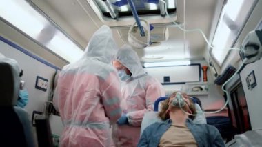 Doktorlar koronavirüs testi örnekleri tutuyor. Hasta hastaneye naklediliyor.