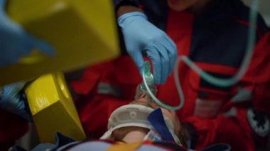 Sağlık görevlileri insanlara ilk yardım sağlıyor. Doktorlar kurbanın üzerinde oksijen maskesi tutuyor. 