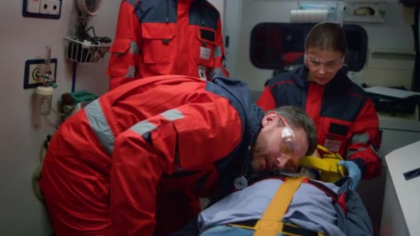 EMS παραϊατρικό προσωπικό που παρέχει τη διαδικασία πρώτων βοηθειών στον ασθενή σε όχημα έκτακτης ανάγκης — Αρχείο Βίντεο