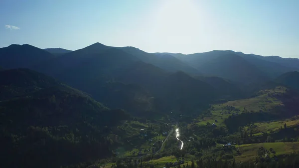 Aerial green mountains landscape charming spruce woods against morning sun — Stock fotografie