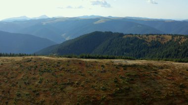 Stunning green mountain road summer season against big beautiful rocky peaks
