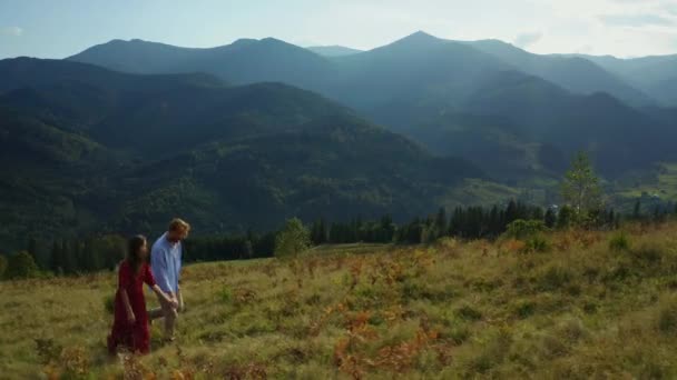 Joyful lovers in mountains drone view against amazing woods pikes background — Stock video
