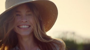 Happy woman face laughing in sunshine outdoor. Beautiful lady in sky background