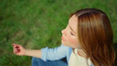 View from above of pretty girl sitting in yoga asana. Closeup girl in meditation