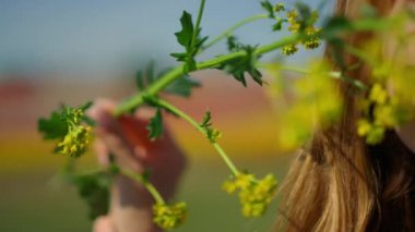 Gentle lady portrait with blooming colza. Woman face smiling to nature outdoors.