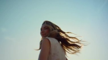 Closeup happy woman in love dancing in light outdoors. Smiling woman in sunshine