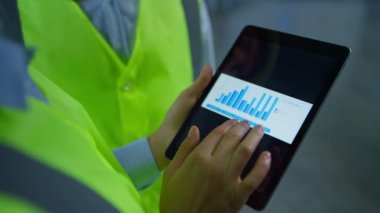 Fabrika çalışanları tablet ekranındaki verileri analiz ediyor.