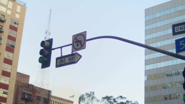 Traffic lights road signs hanging over street. Traffic regulation in city. — Stock Video