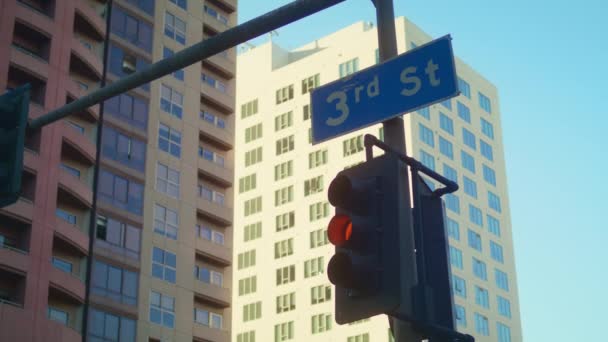 Traffic regulation signs hanging over road on cityscape background close up — Stock Video