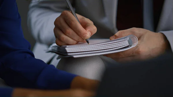 Businessman hand writing notebook working at corporate meeting office workplace. — Stock Photo, Image