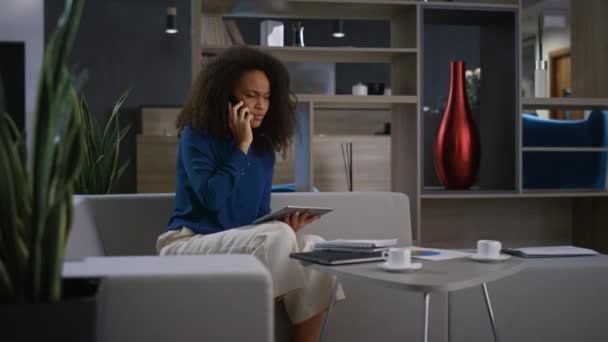 Молодая африканская деловая женщина из Америки разговаривает по телефону в офисе. Концепция удаленной работы. — стоковое видео