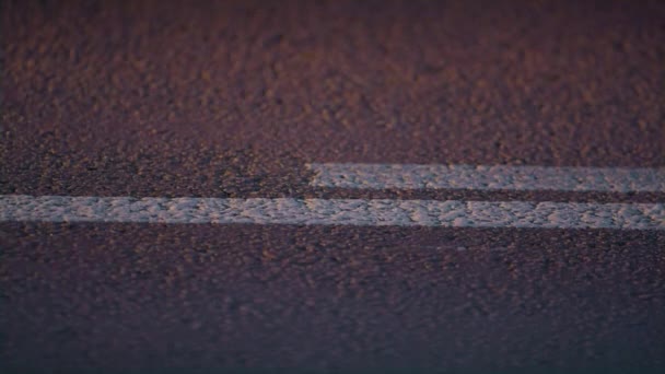 Road double lines marking beginning on asphalt highway closeup. Traffic control. — Stock Video