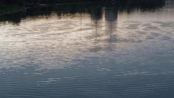 Ruhige Flusswellen spiegeln abstraktes Stadtbild wider. Blaues Wasser — Stockvideo