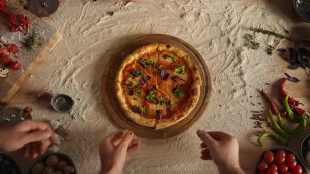 Friends group sharing pizza slice on cutting board table at restaurant pizzeria. — Stock Video